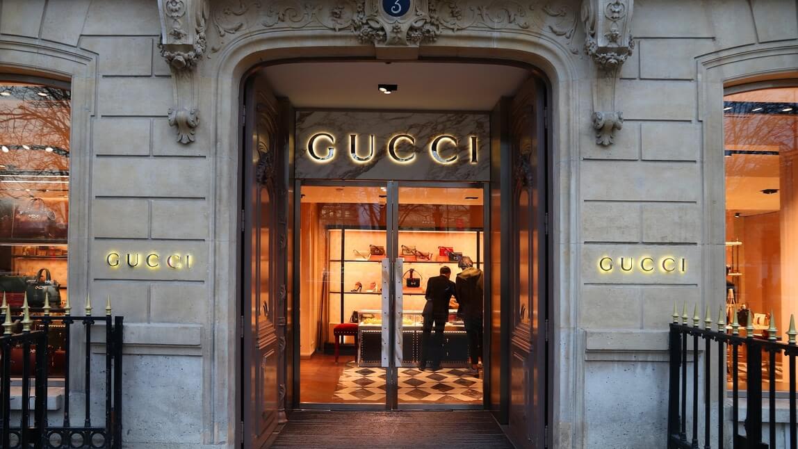 Image of the doors of a Gucci store with the Gucci sign.