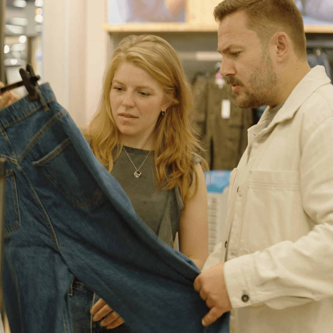 Two people looking and talking about circular jeans
